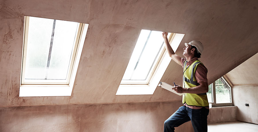 Inspector checking skylights in a new home